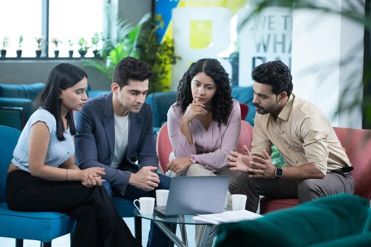 Creative team sharing ideas around a studio table